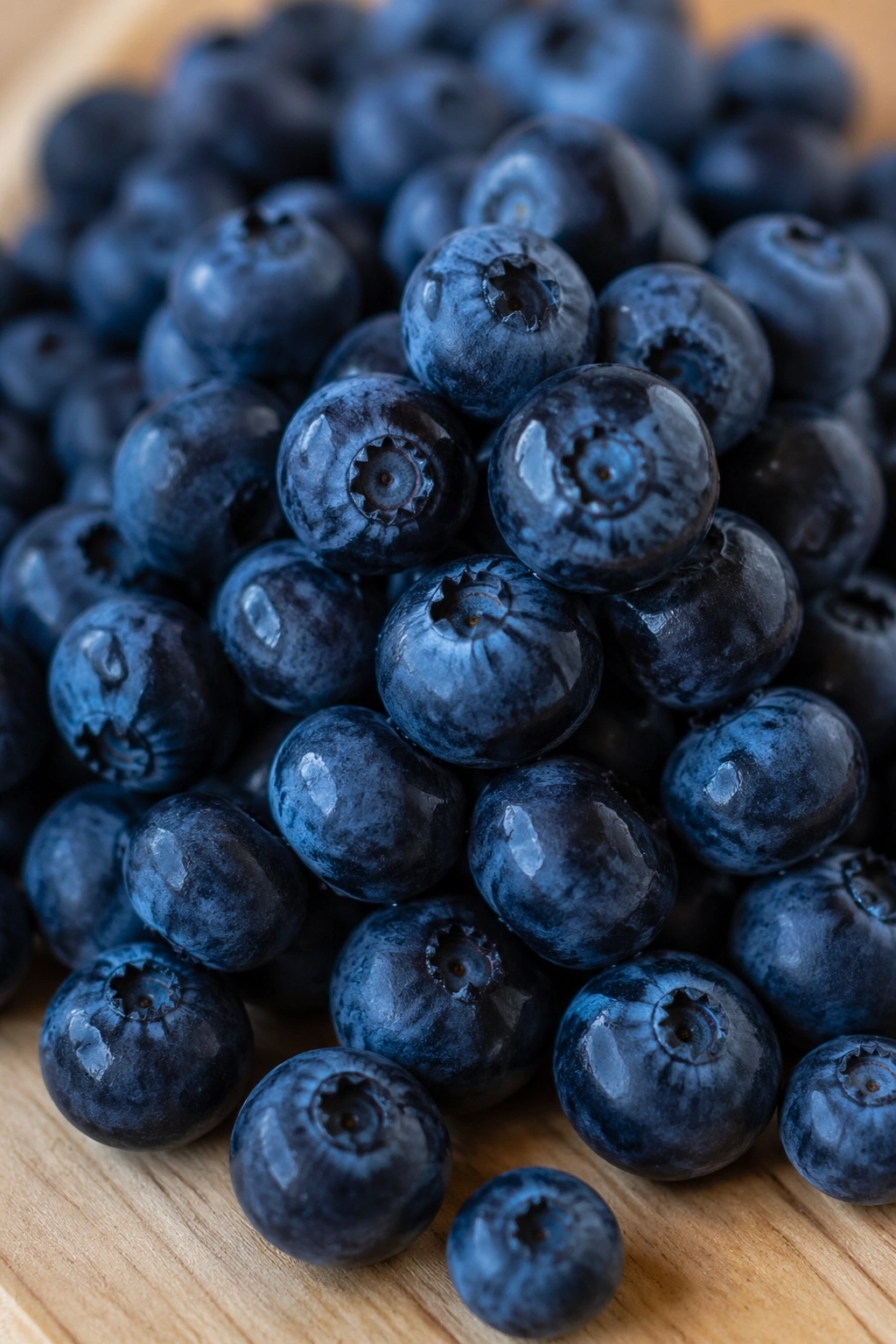 Close-up of fresh blueberries on a wooden surface