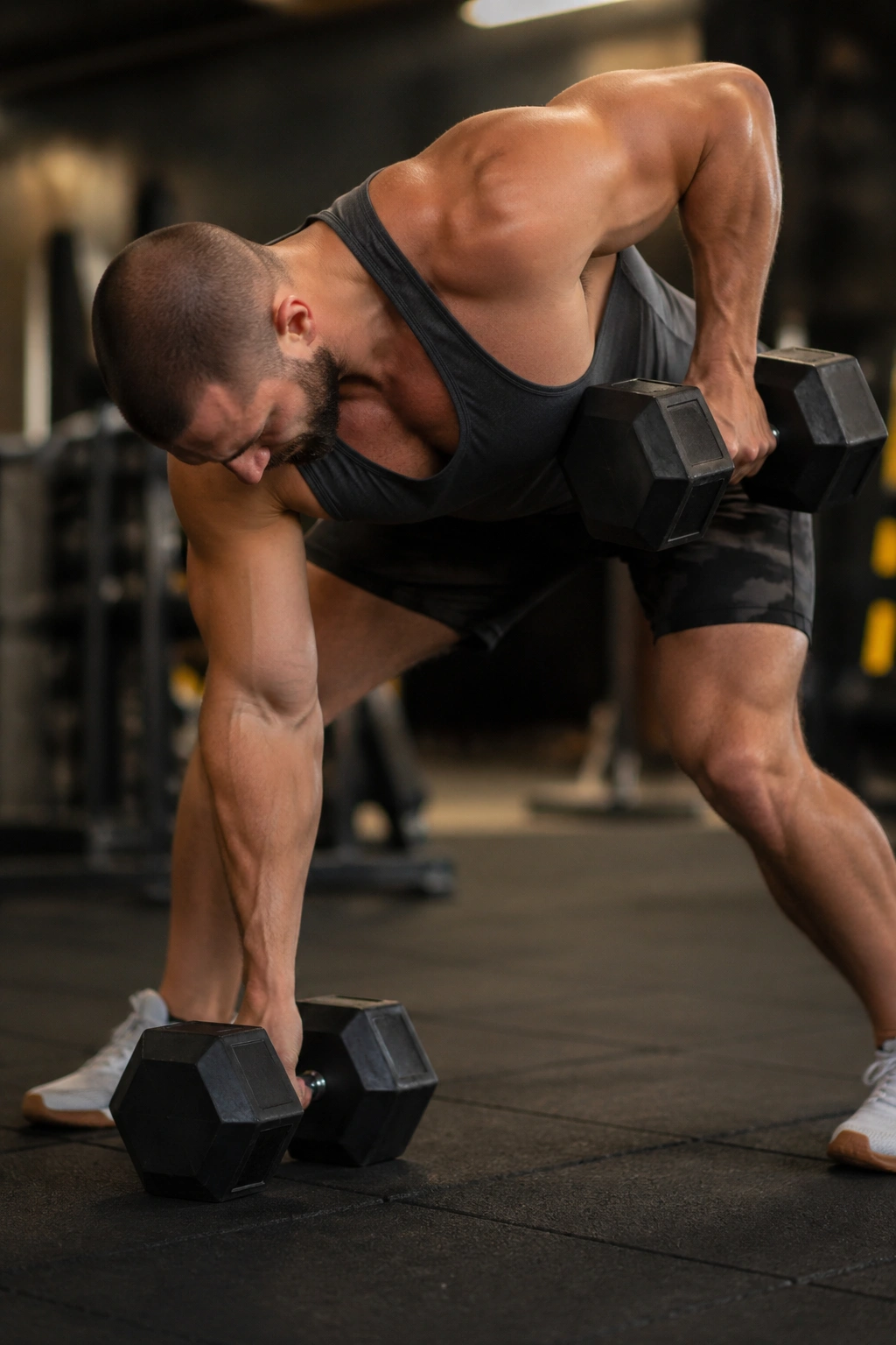 Gorilla row with dumbbells between feet and alternating pulls