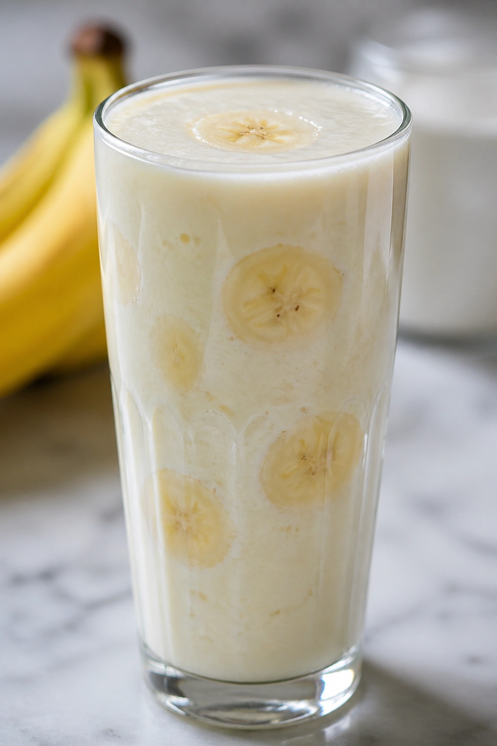 Close-up of a kefir banana smoothie in a glass on a kitchen counter