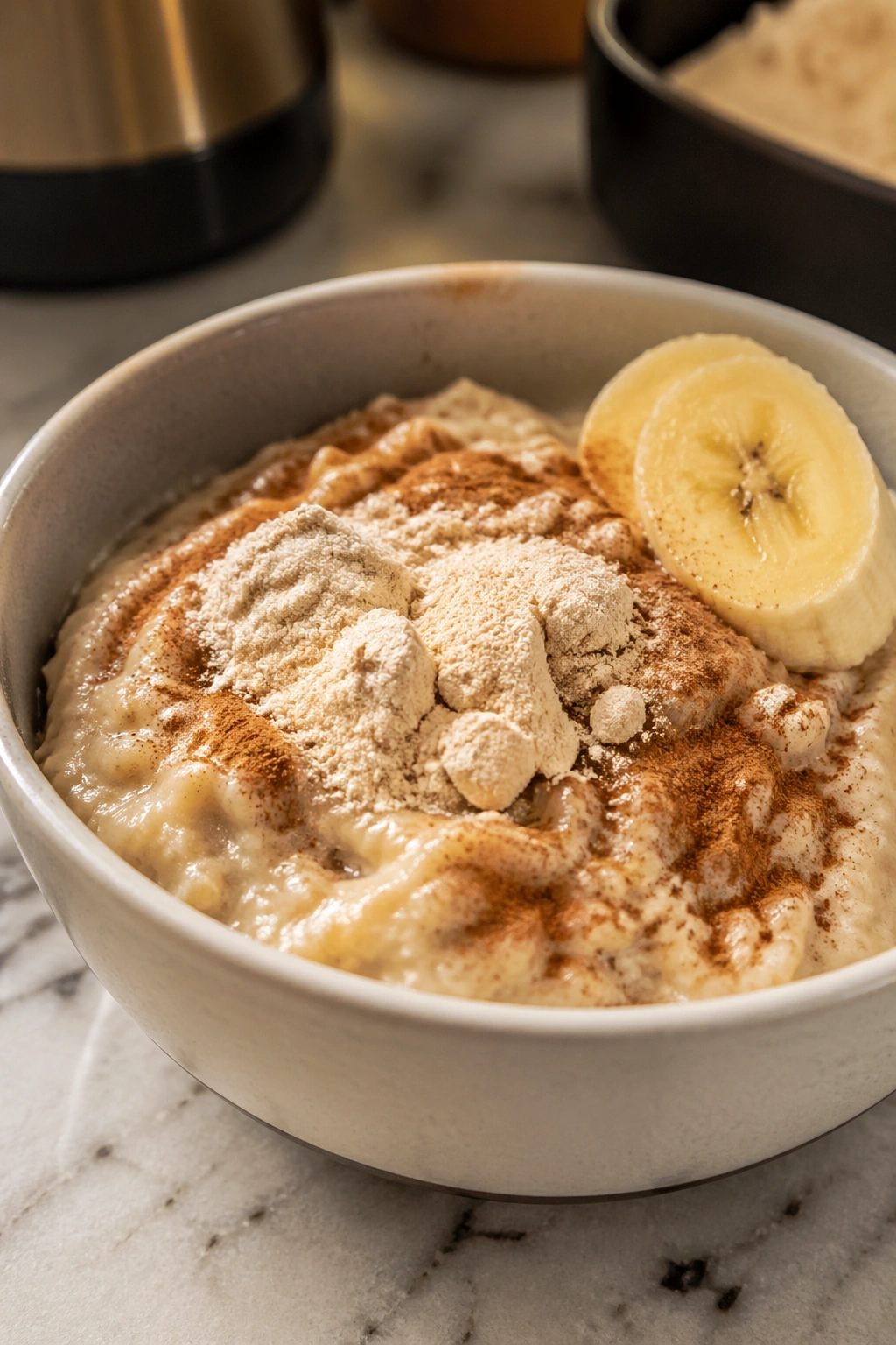 Creamy oatmeal with cinnamon and whey powder swirl in a bowl
