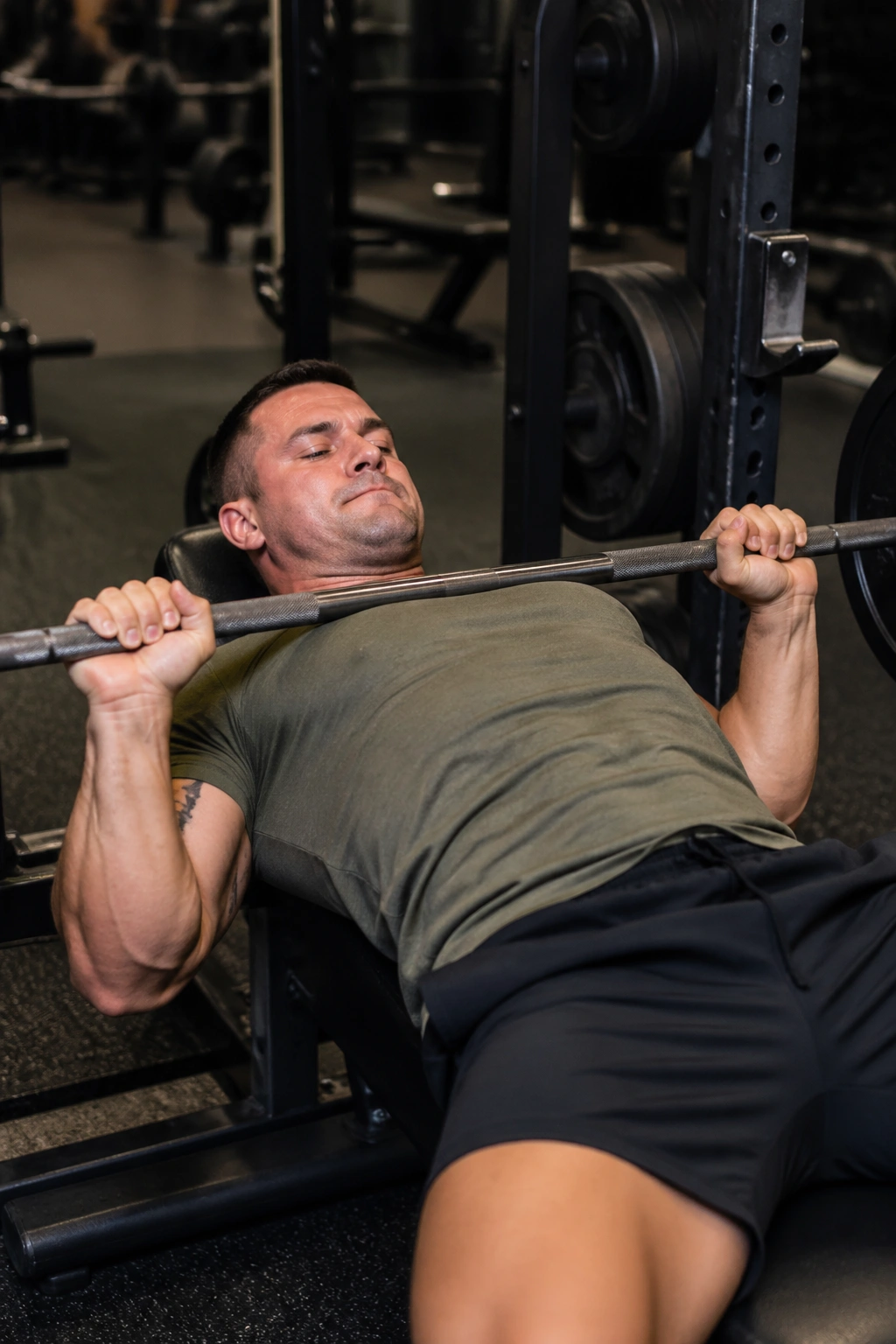 Paused bench press position with bar at chest during practice