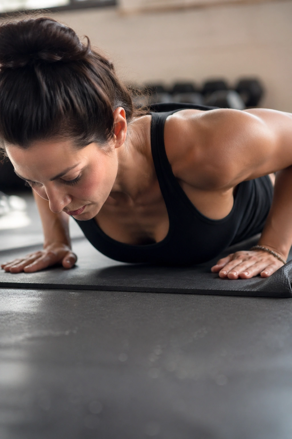 Woman performing push-up with proper body alignment on mat