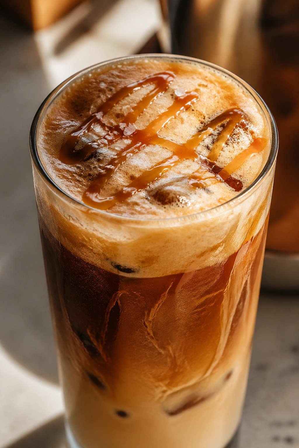 Close-up of Salted Caramel Whey Cold Brew in a glass with caramel foam