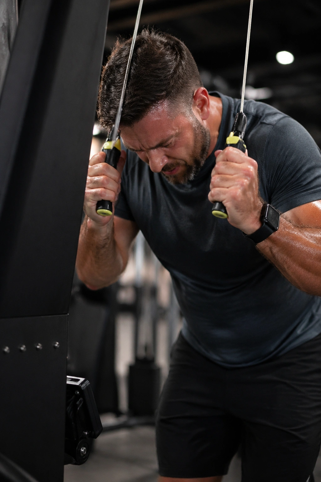 Close up of athlete using the SkiErg machine in a gym