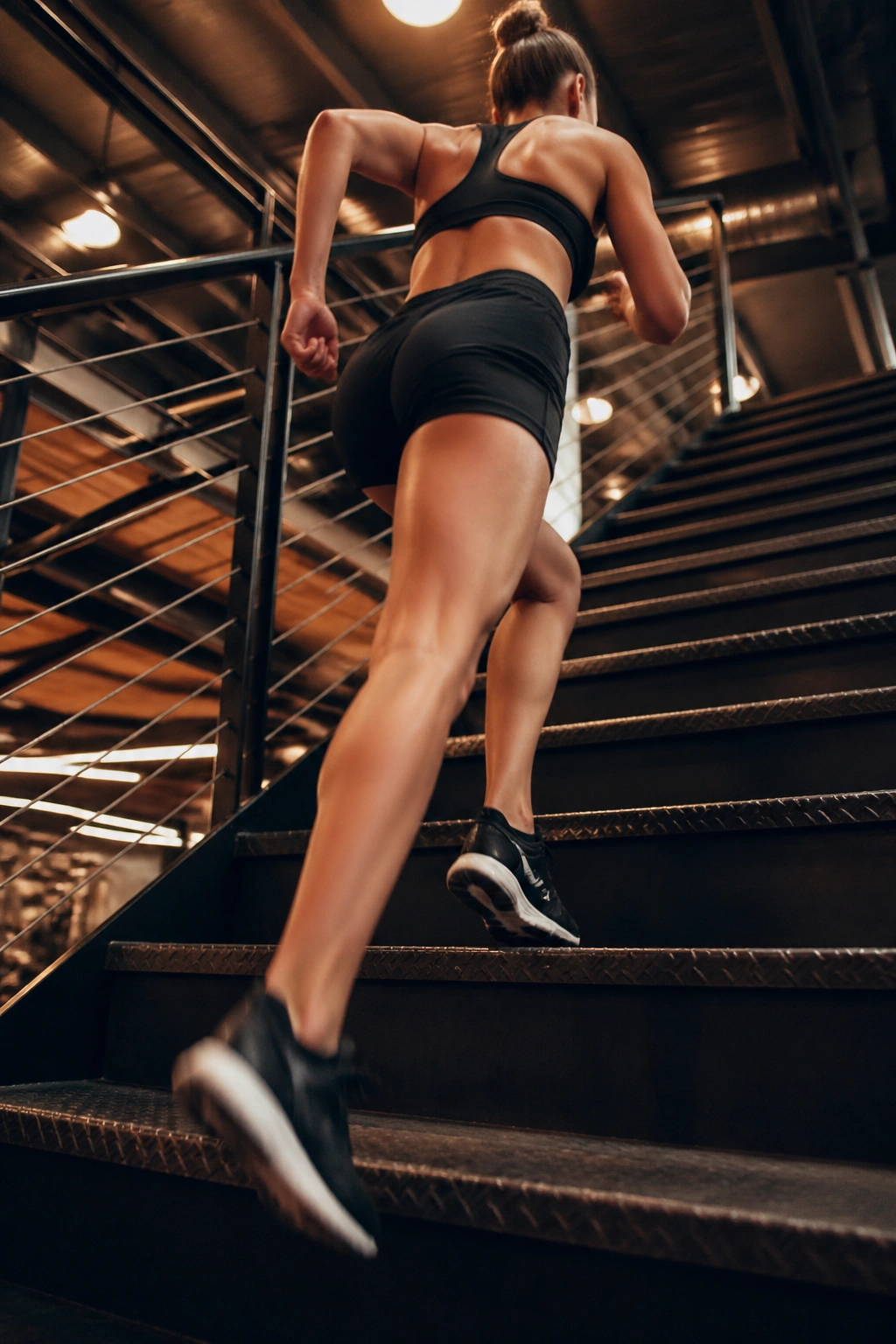 Person climbing stairs in a gym during stair climb repeats.