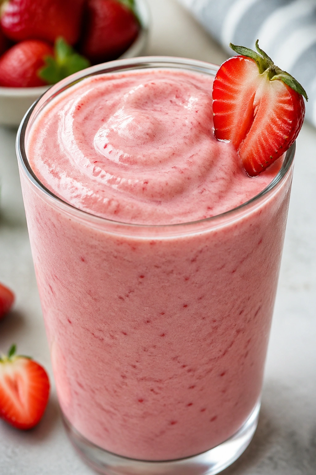 Creamy Strawberry Cottage Cheese Smoothie in a glass on a kitchen counter