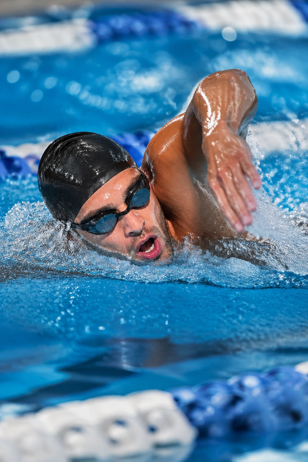 Swimmer sprinting in a pool during ladder intervals