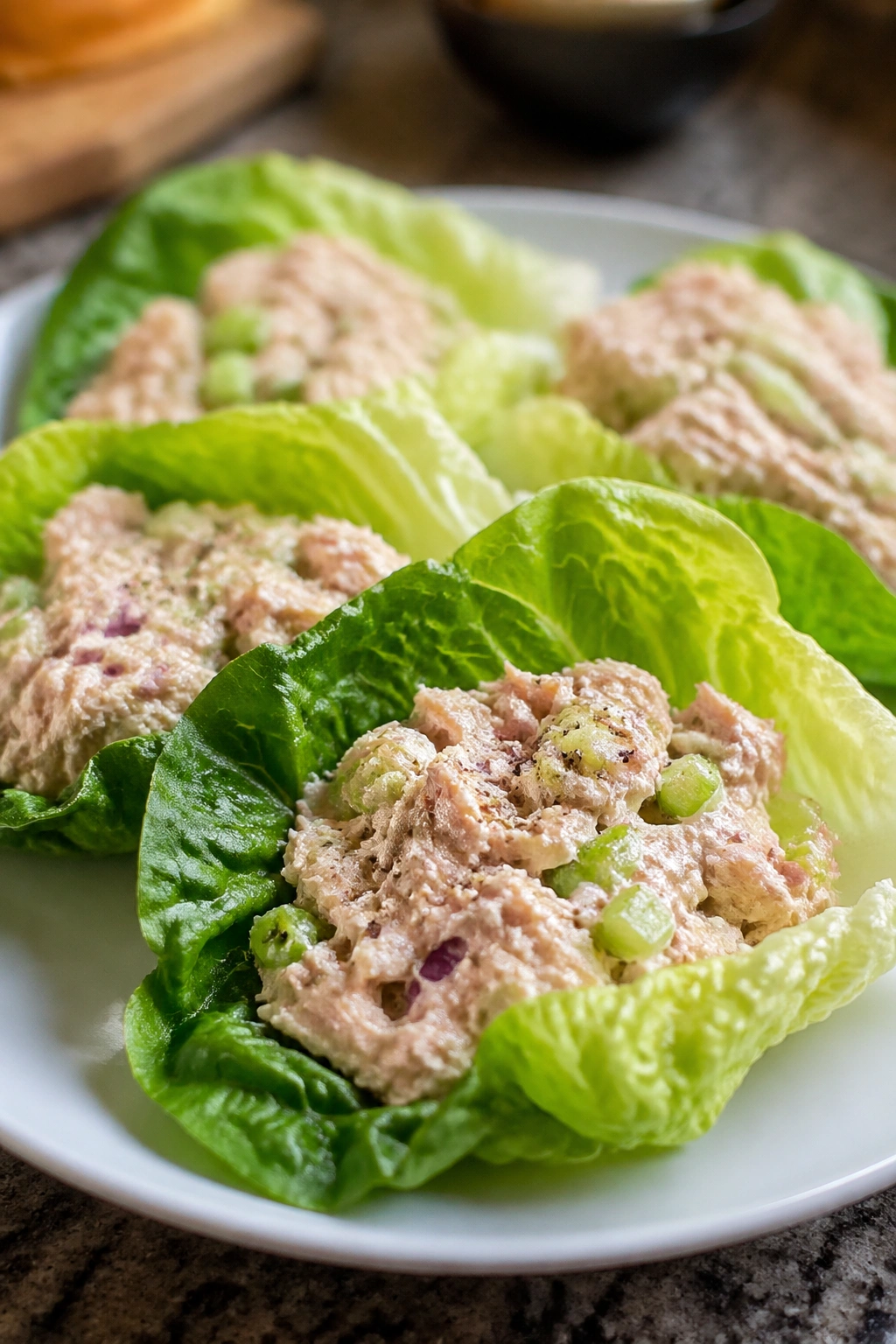 Lettuce cups filled with tuna salad on a plate