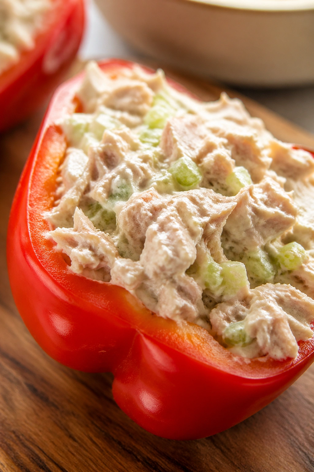 Close-up of tuna salad stuffed peppers on a wooden cutting board