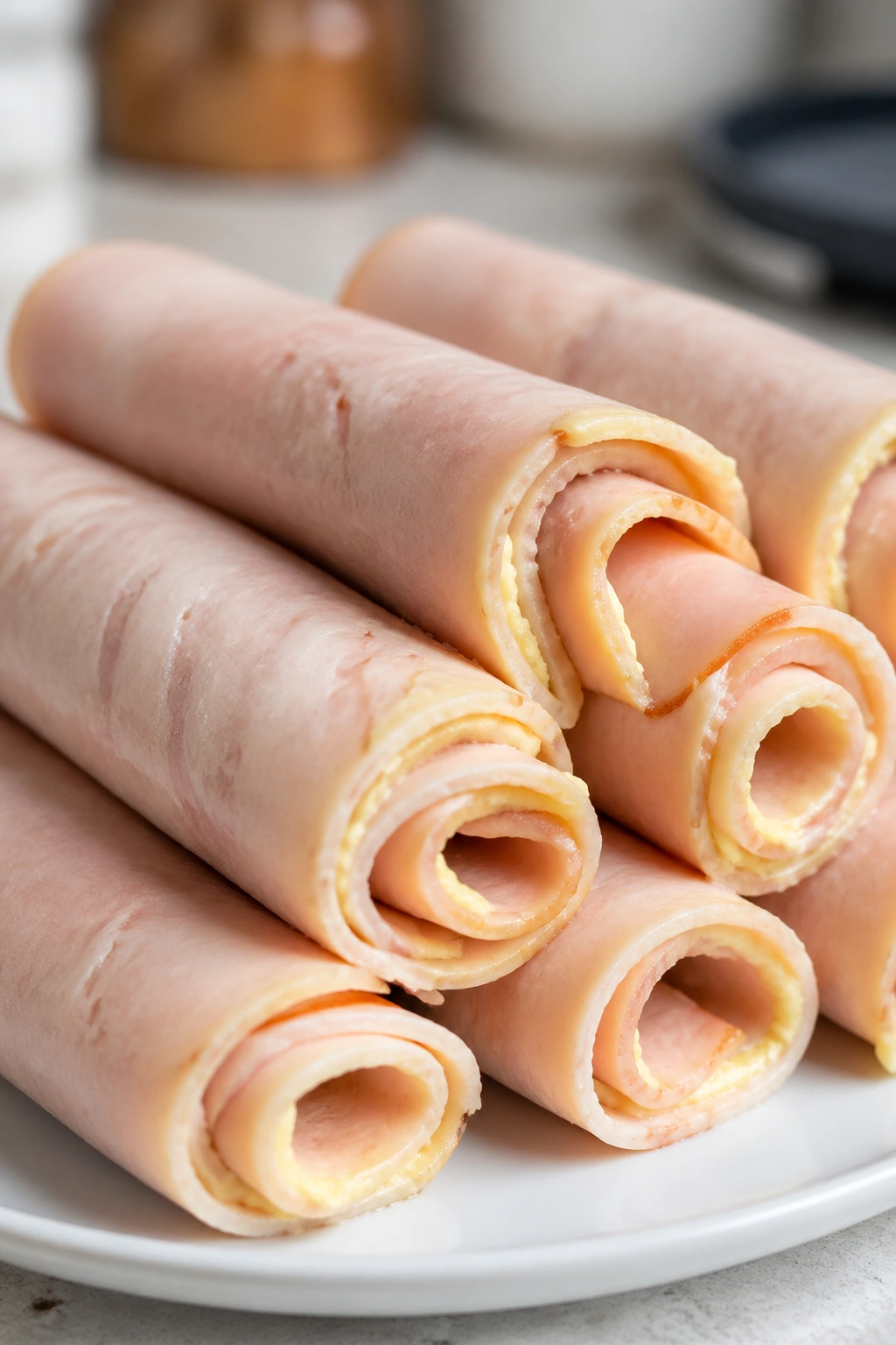 Close-up of turkey and hummus roll-ups on a plate