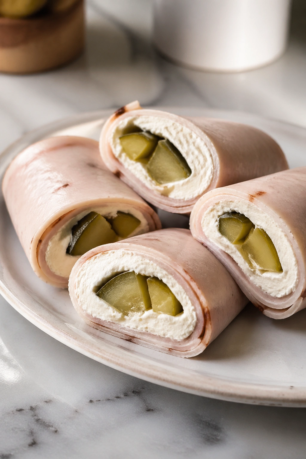 Turkey roll-ups with cream cheese and pickles on a plate