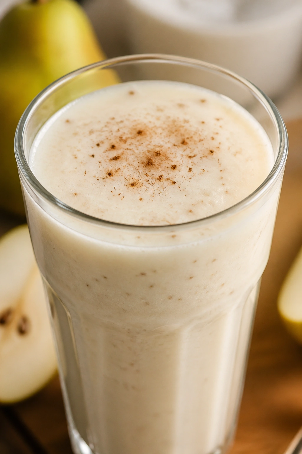 Creamy vanilla pear cottage cheese smoothie in glass on warm kitchen counter