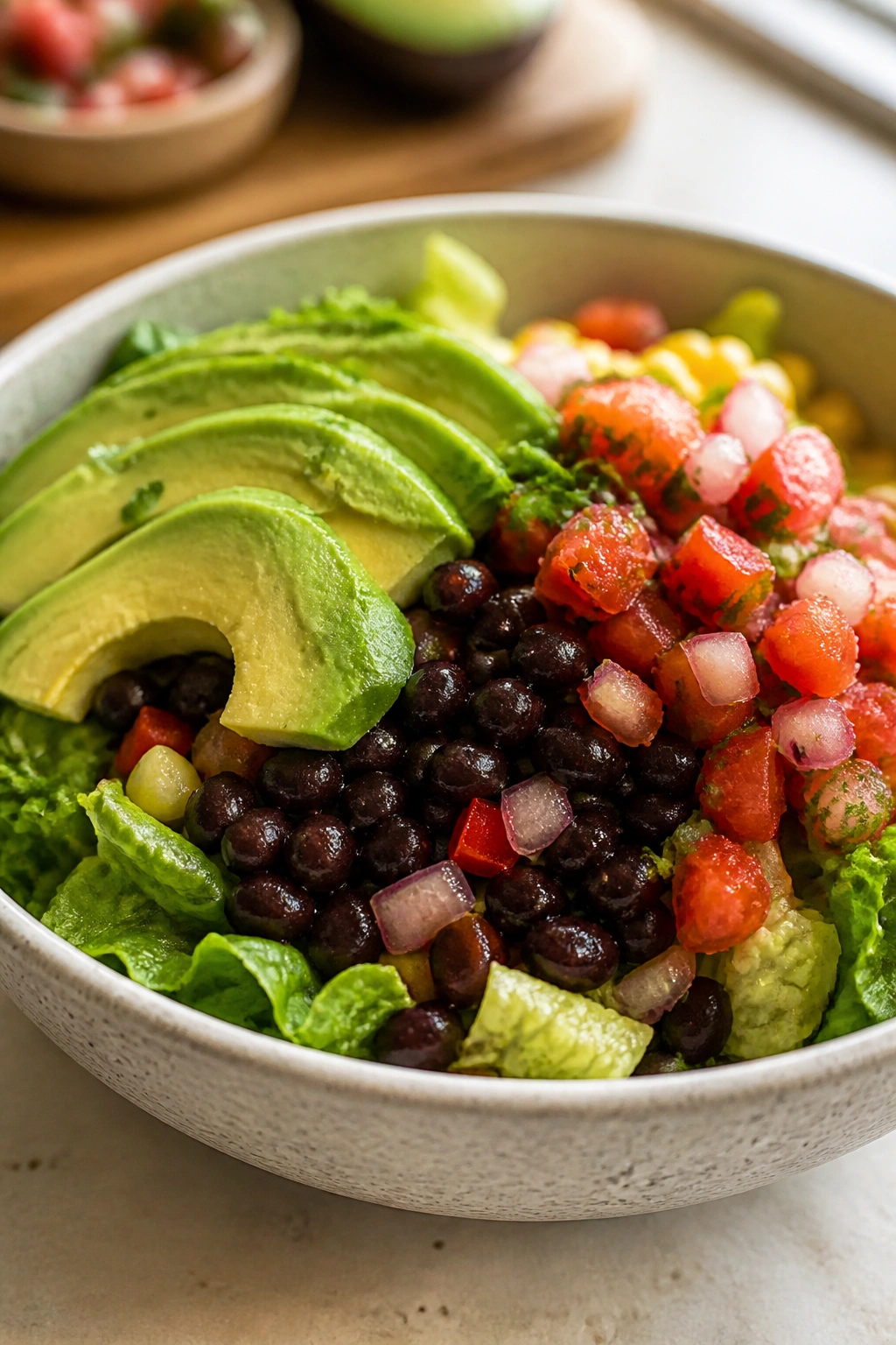 Close-up of black bean taco bowl with avocado and salsa