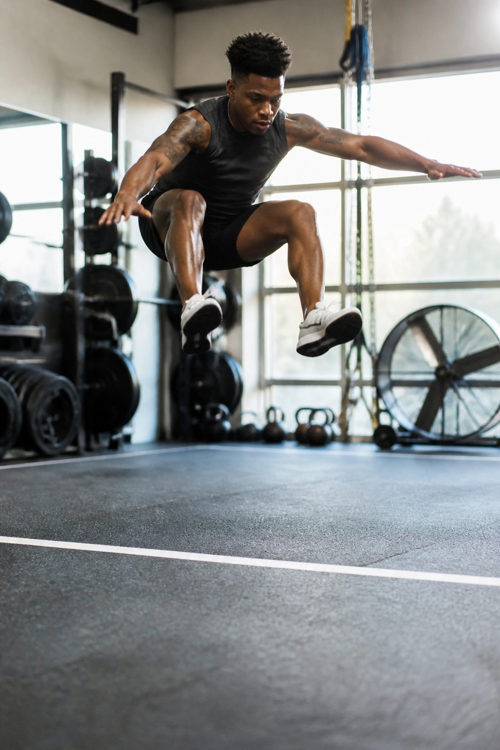 Athlete performing broad jump for power in a gym