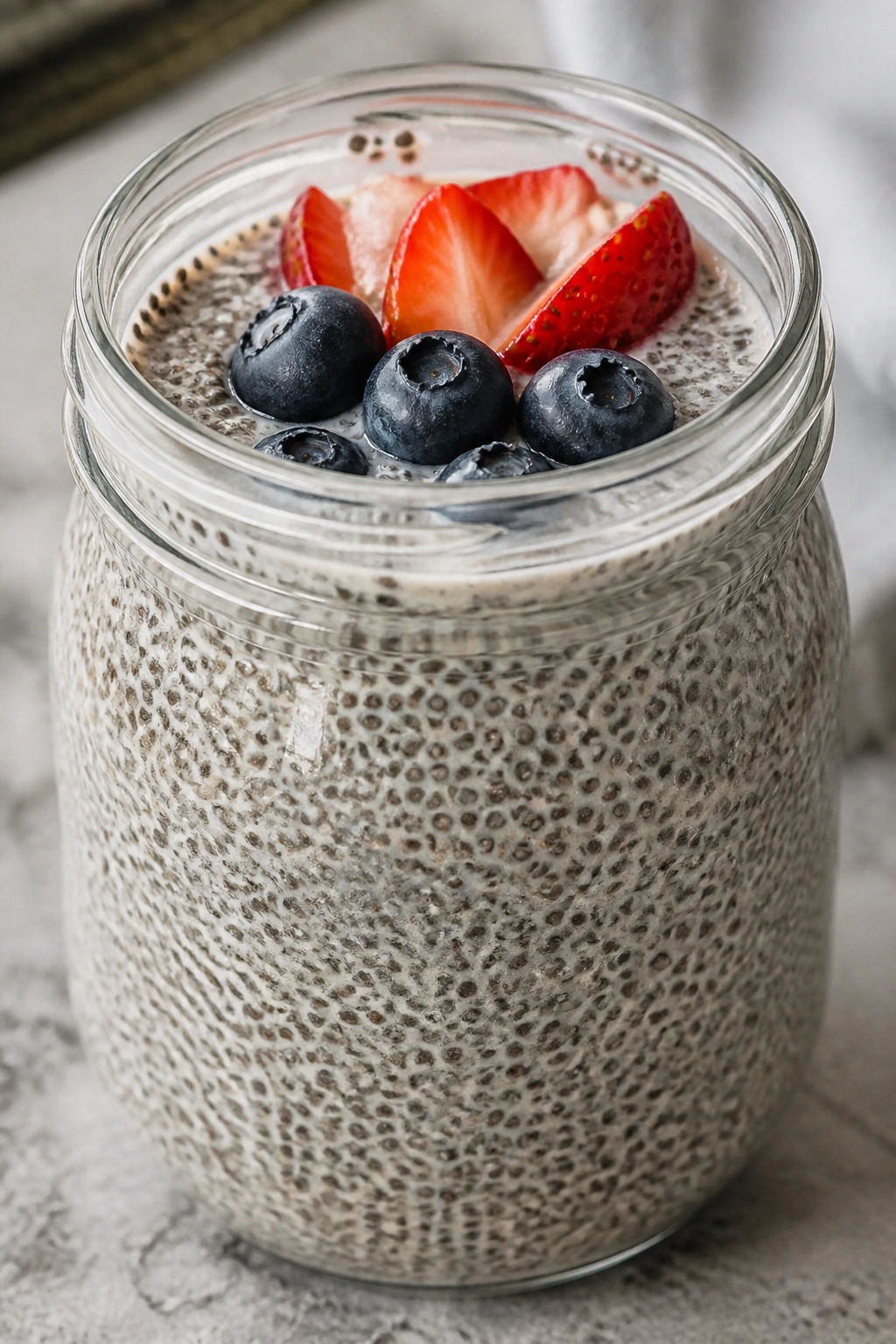 Chia seed pudding in glass jar on kitchen counter