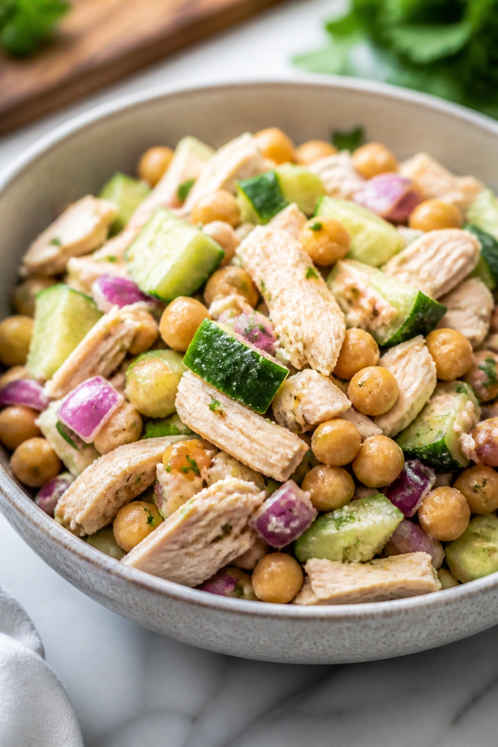 Chickpea and chicken salad in a bowl on a kitchen counter