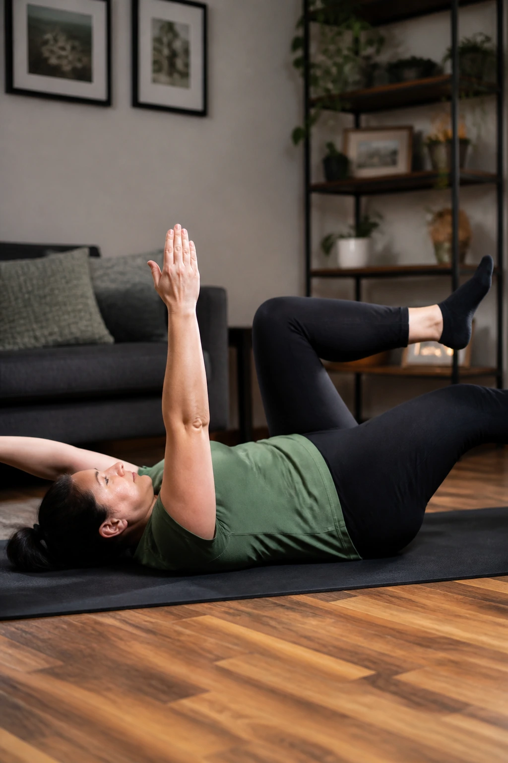 Person performing dead bug drill on a mat in a living room.