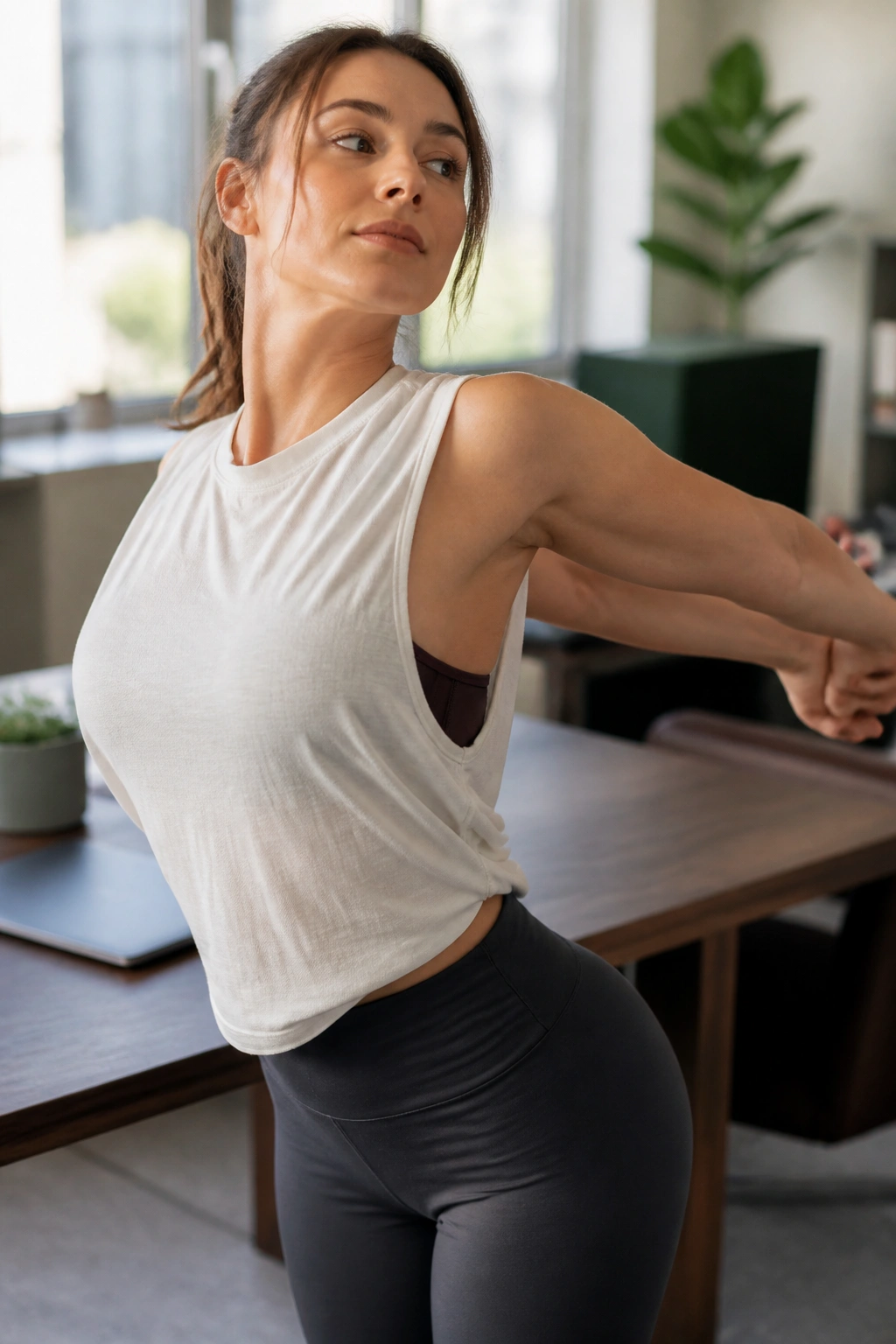 Person at desk performing gentle desk-relief stretch