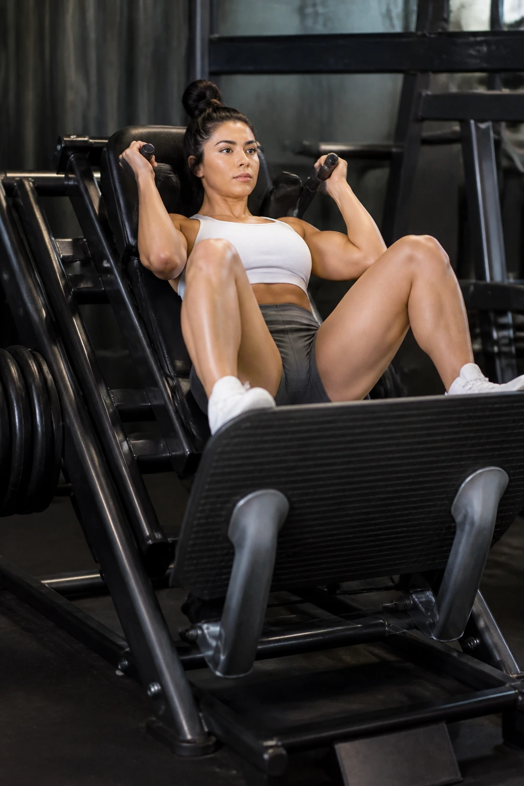 Mid-shot of hack squats showing wide feet and glute engagement