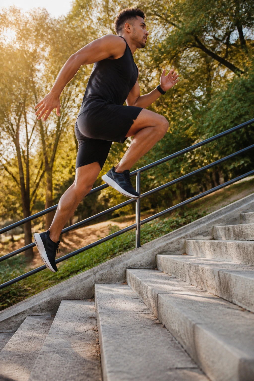 Athlete bounding up outdoor stairs in motion