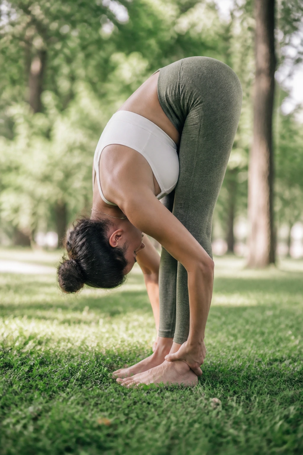 Person in standing forward fold outdoors with knees bent