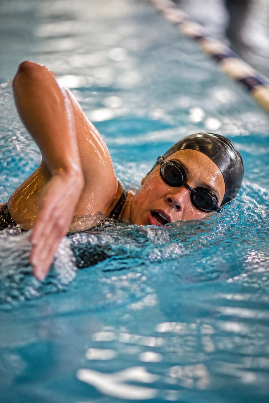 Swimmer mid-stroke in pool during short rest period