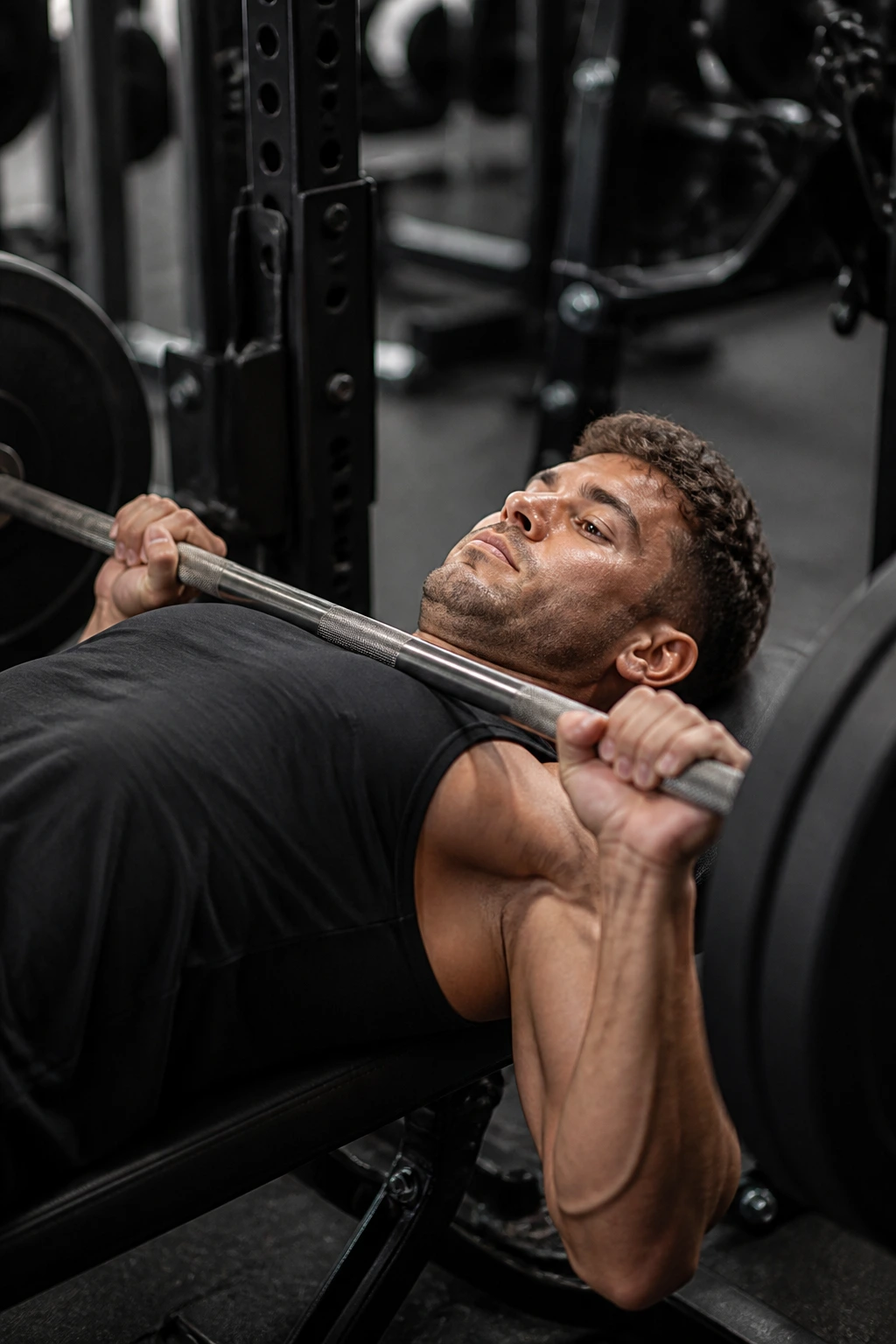 Lifter bench pressing with slow tempo, controlled lowering