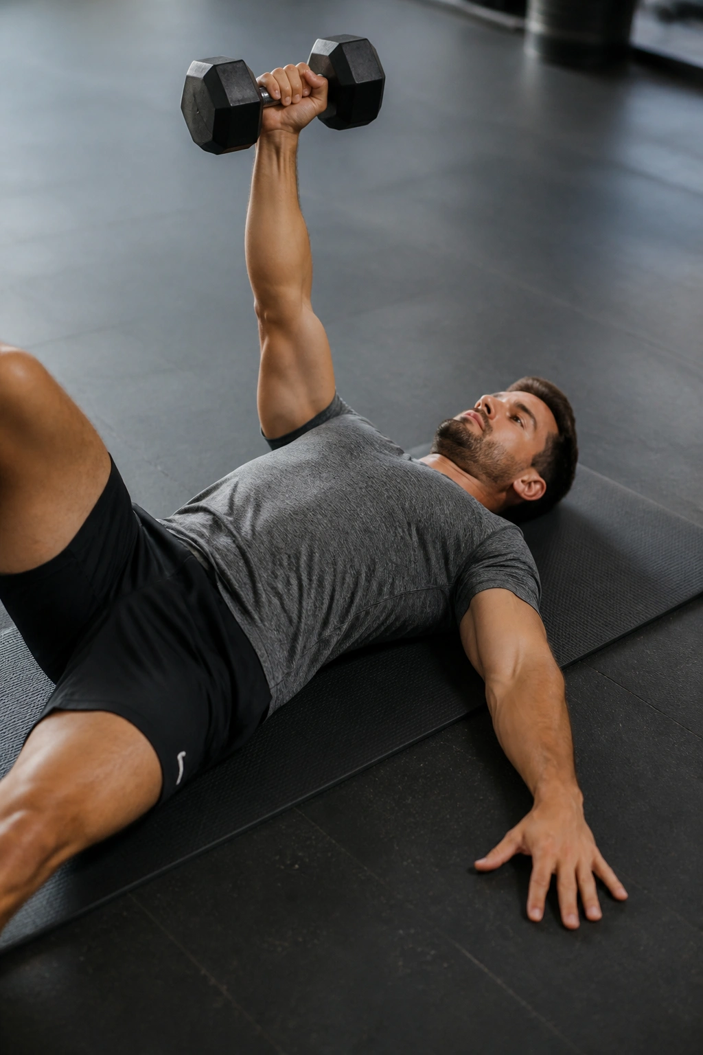Single-arm floor press with dumbbell on a real person