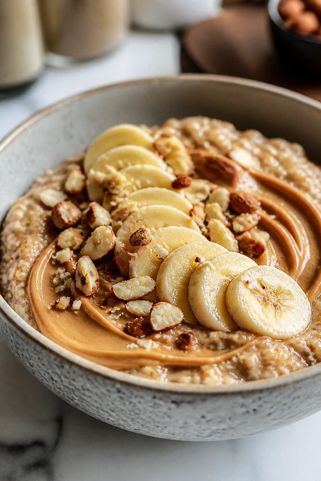Close-up of a calorie-dense bowl with peanut butter oats banana and nuts for hardgainer plan