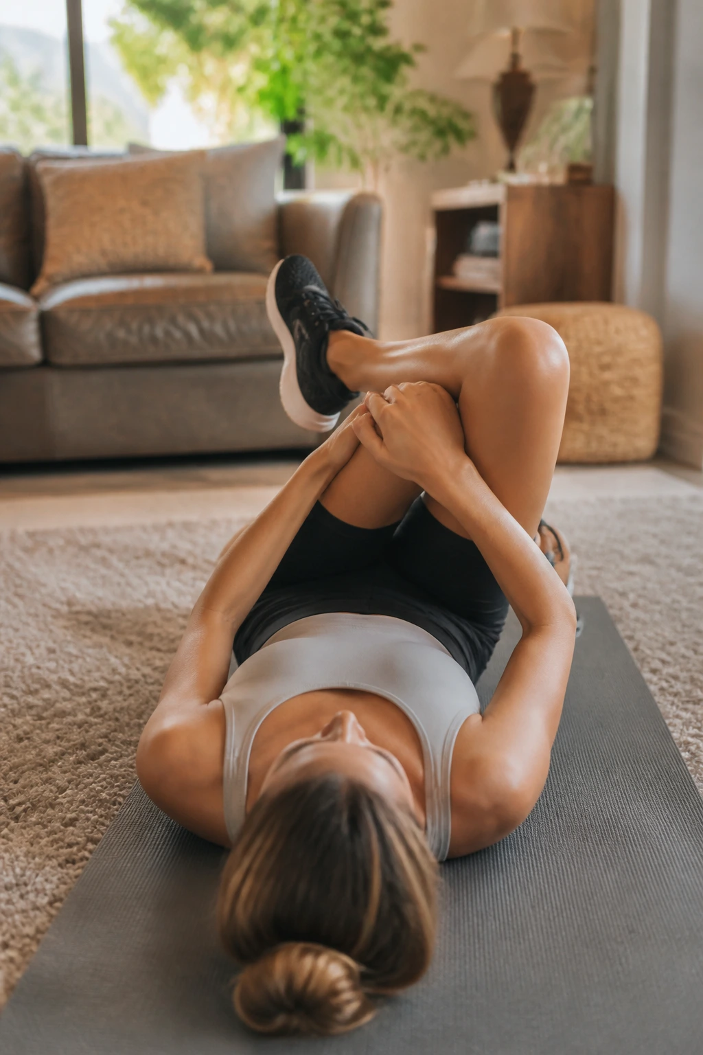 Close up of person performing figure-four stretch on yoga mat
