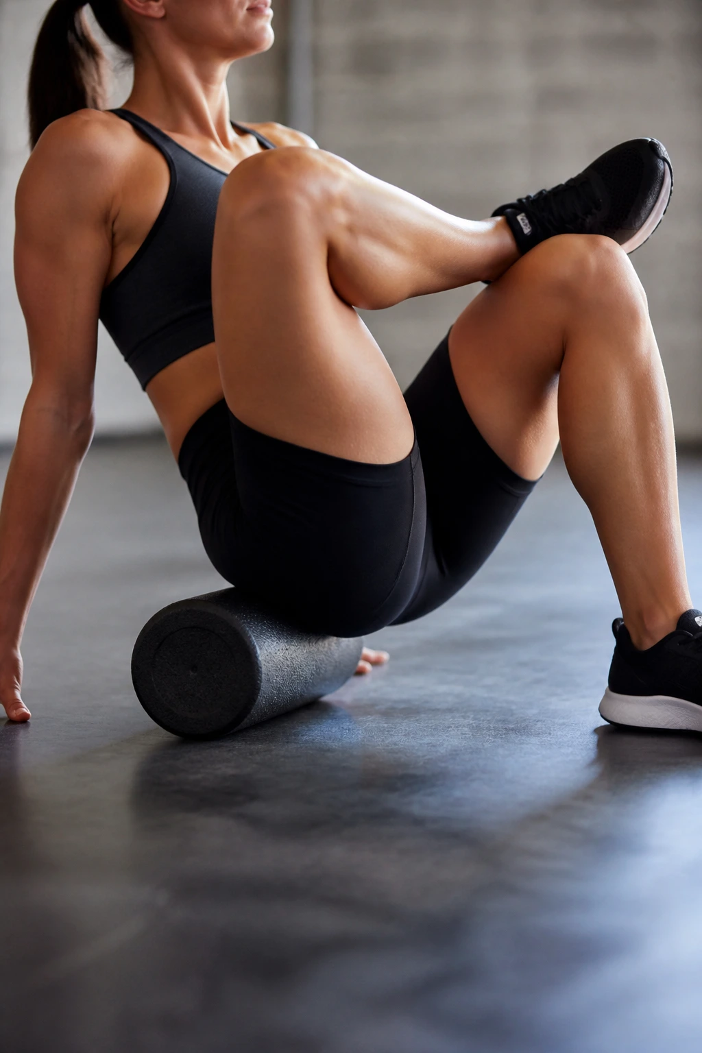 Glute muscle being rolled in a figure-four position