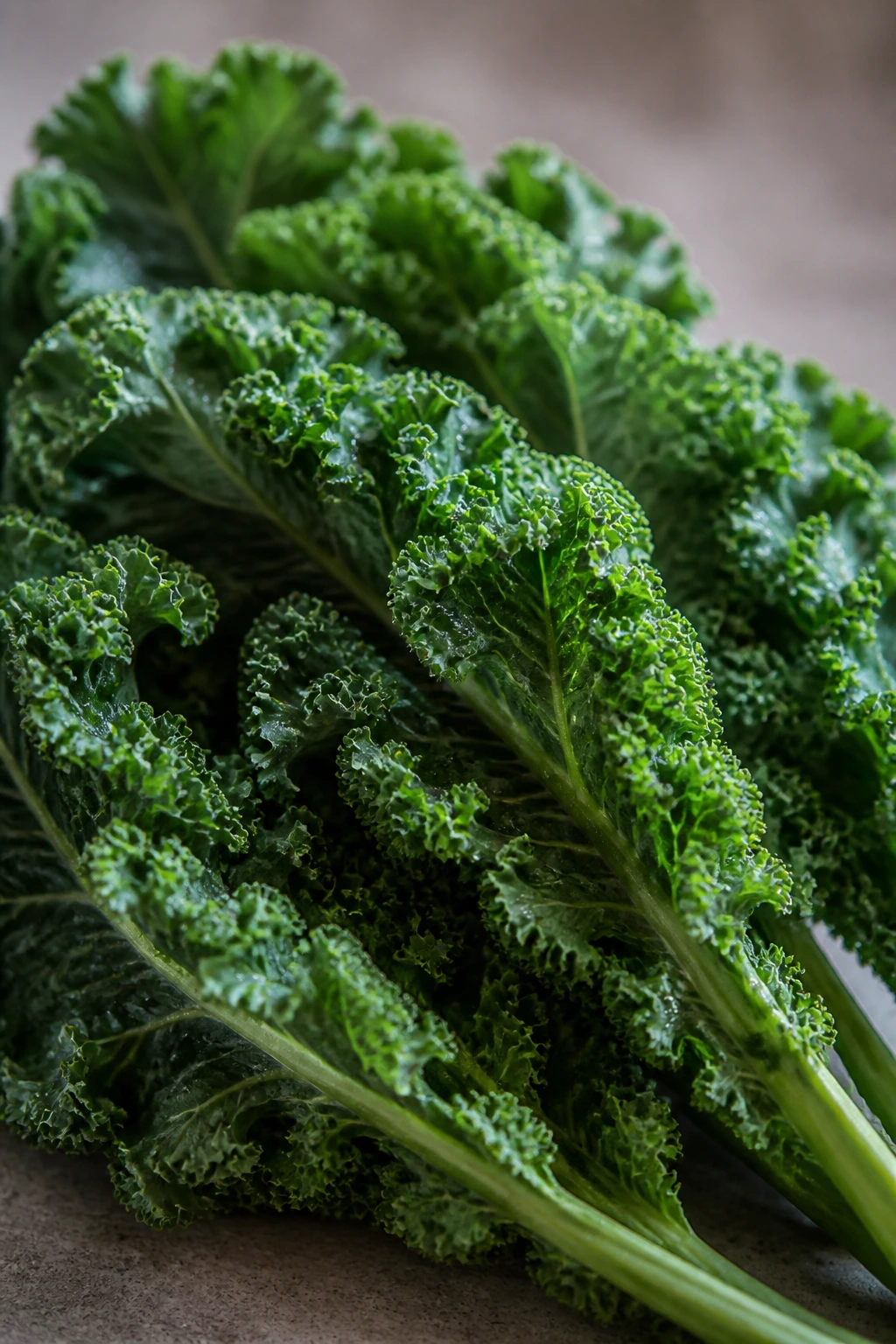 Close-up of kale leaves filling the frame on kitchen surface