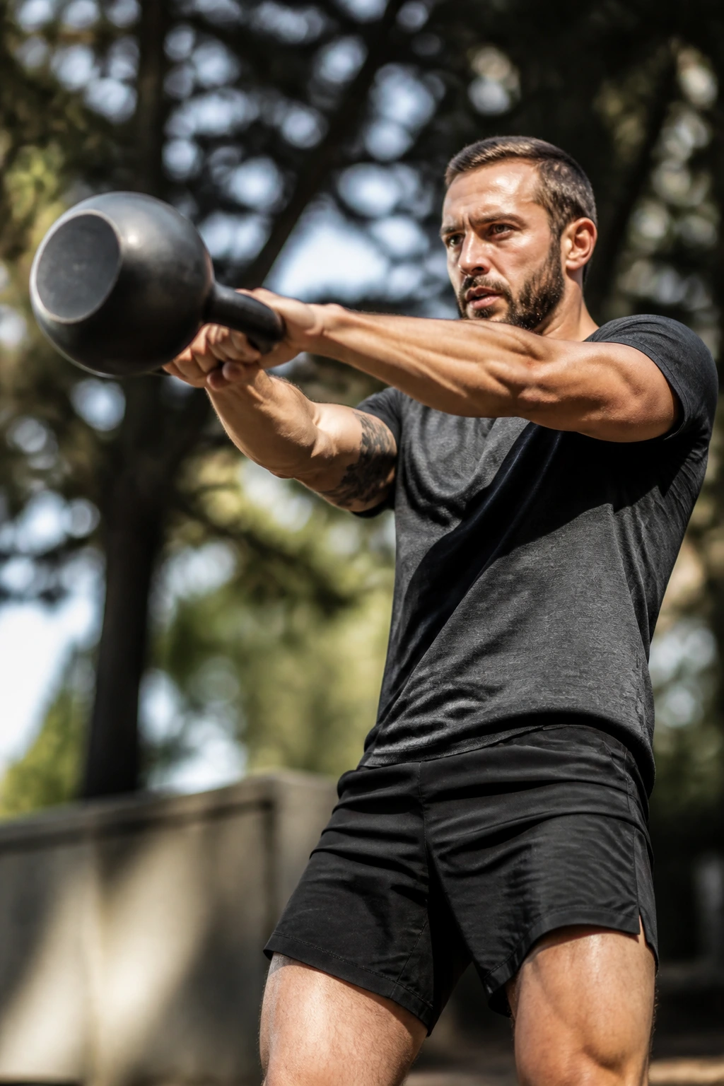 Person performing a kettlebell swing outdoors