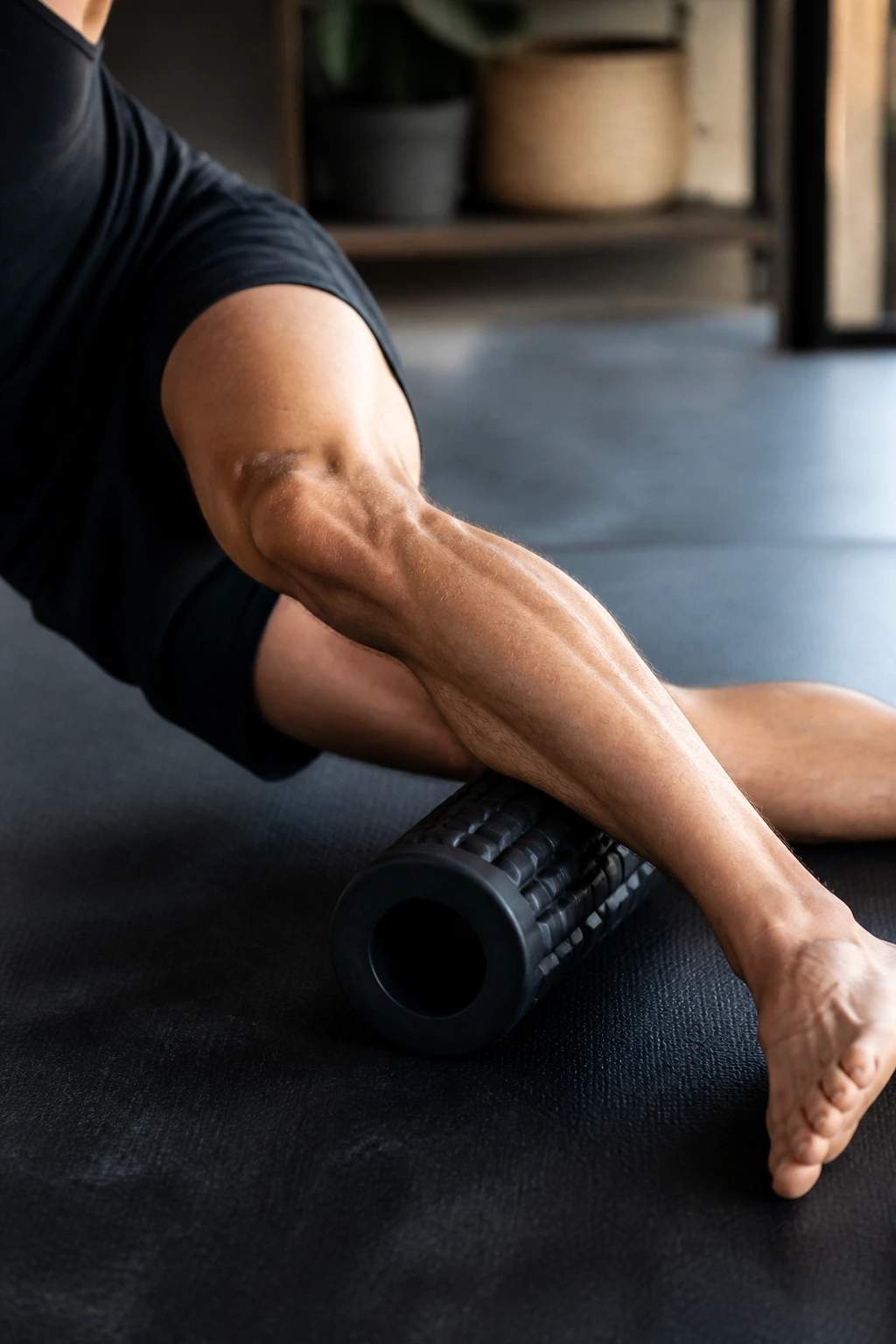 Outer lower leg being rolled to target peroneal muscles