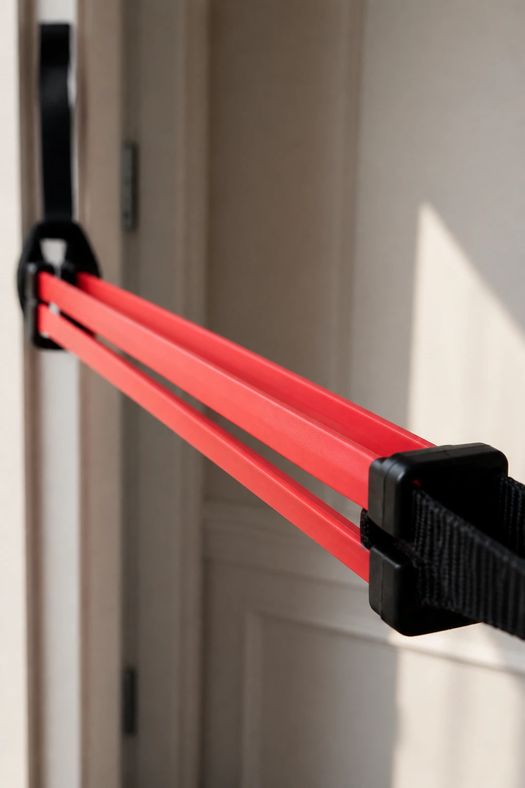 Close-up of a bright resistance band stretched tight between anchors