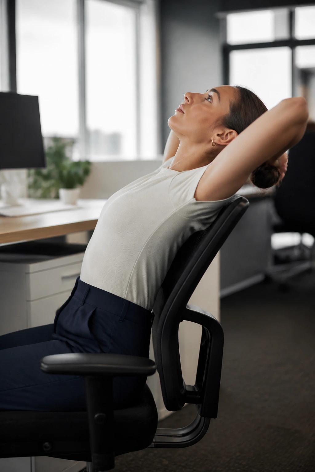 Person performing seated thoracic extension at office chair