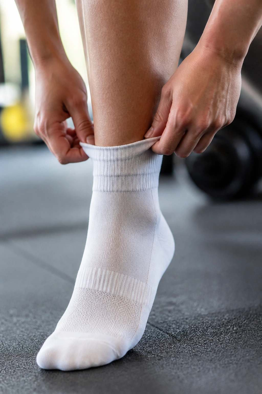 Person wearing a clean moisture-wicking sock in a gym setting