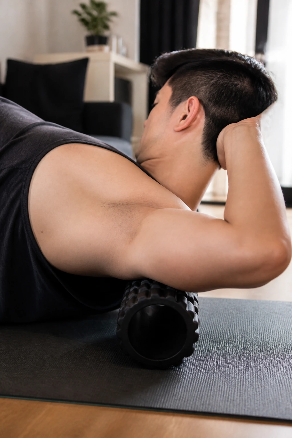 Side-lying with foam roller under upper arm to release the triceps